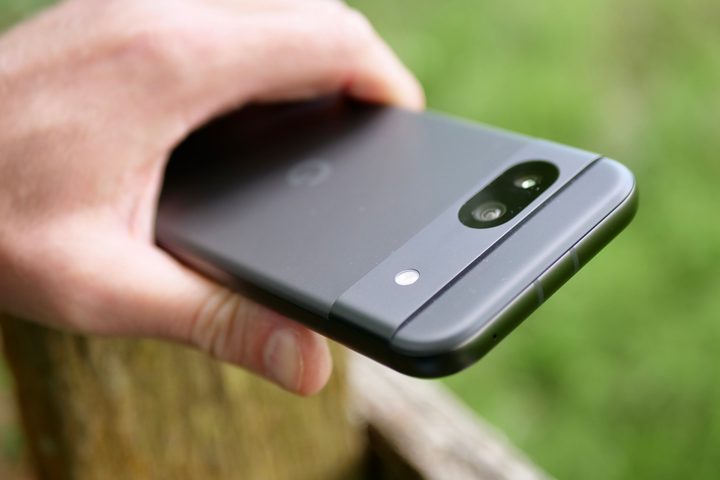 A person holding the Google Pixel 8a, showing the camera visor.