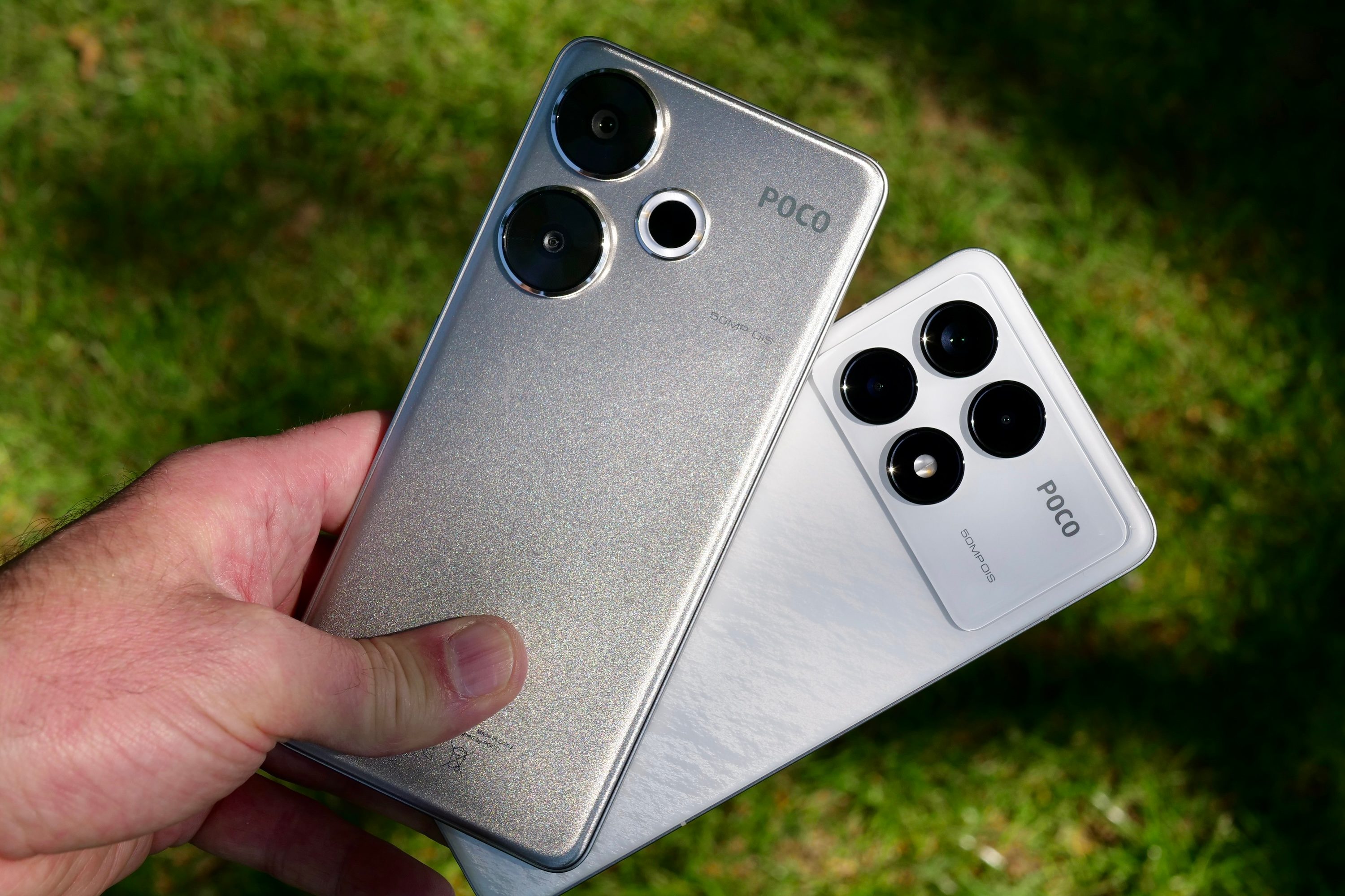 A person holding the Poco F6 and Poco F6 Pro.
