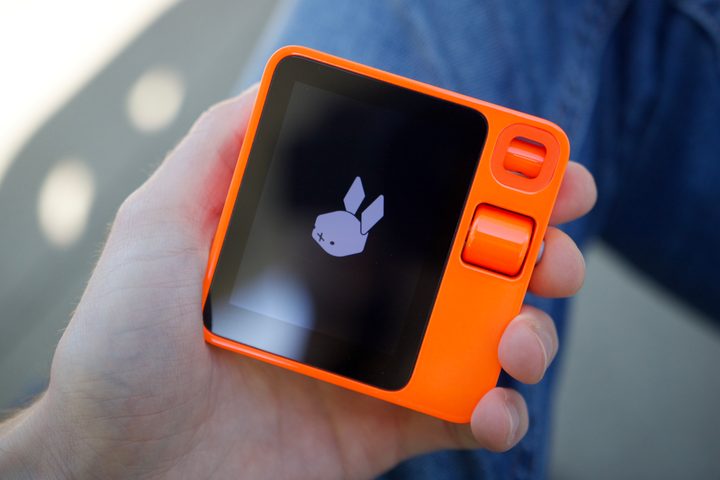 Someone holding the Rabbit R1.