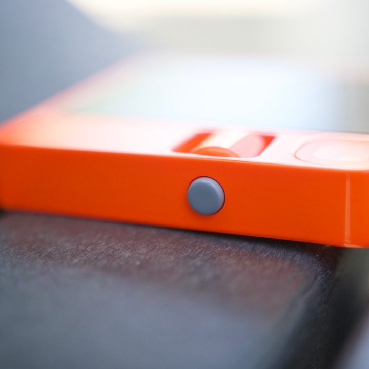The side of the Rabbit R1, showing its button.