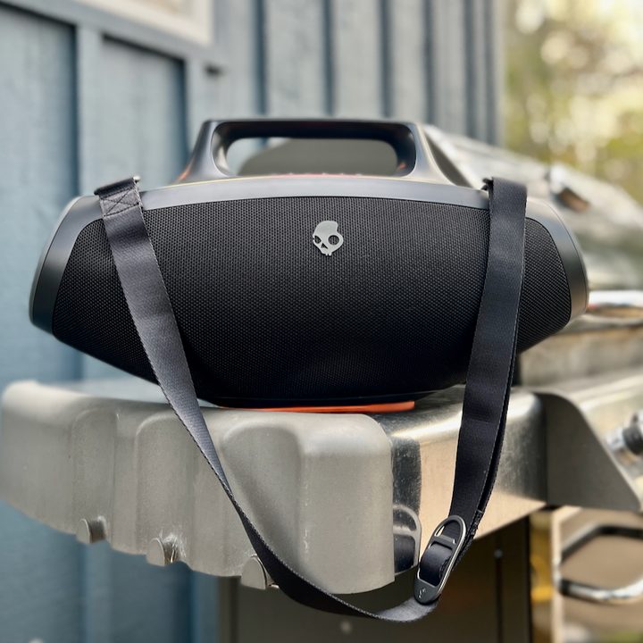 The Skullcandy Barrel Bluetooth speaker on a barbecue.