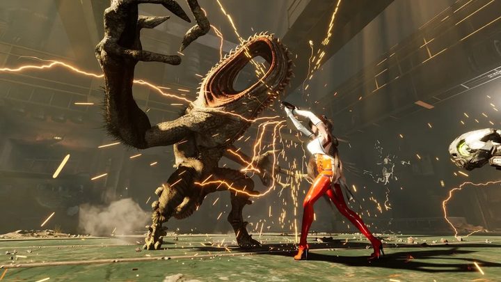 Eve fighting a large boss, with sparks flying around them. She's in the new NeuroLink Suit, which has tight red pants and a white top.