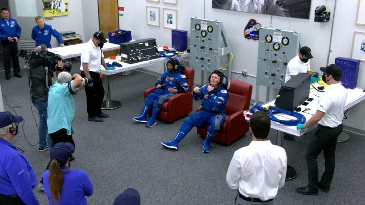 NASA’s Boeing Crew Flight Test astronauts Butch Wilmore and Suni Williams perform checks of their Boeing spacesuits in the crew suit-up room inside the Neil A. Armstrong Operations and Checkout Building at NASA’s Kennedy Space Center in Florida on Monday, May 6, 2024.