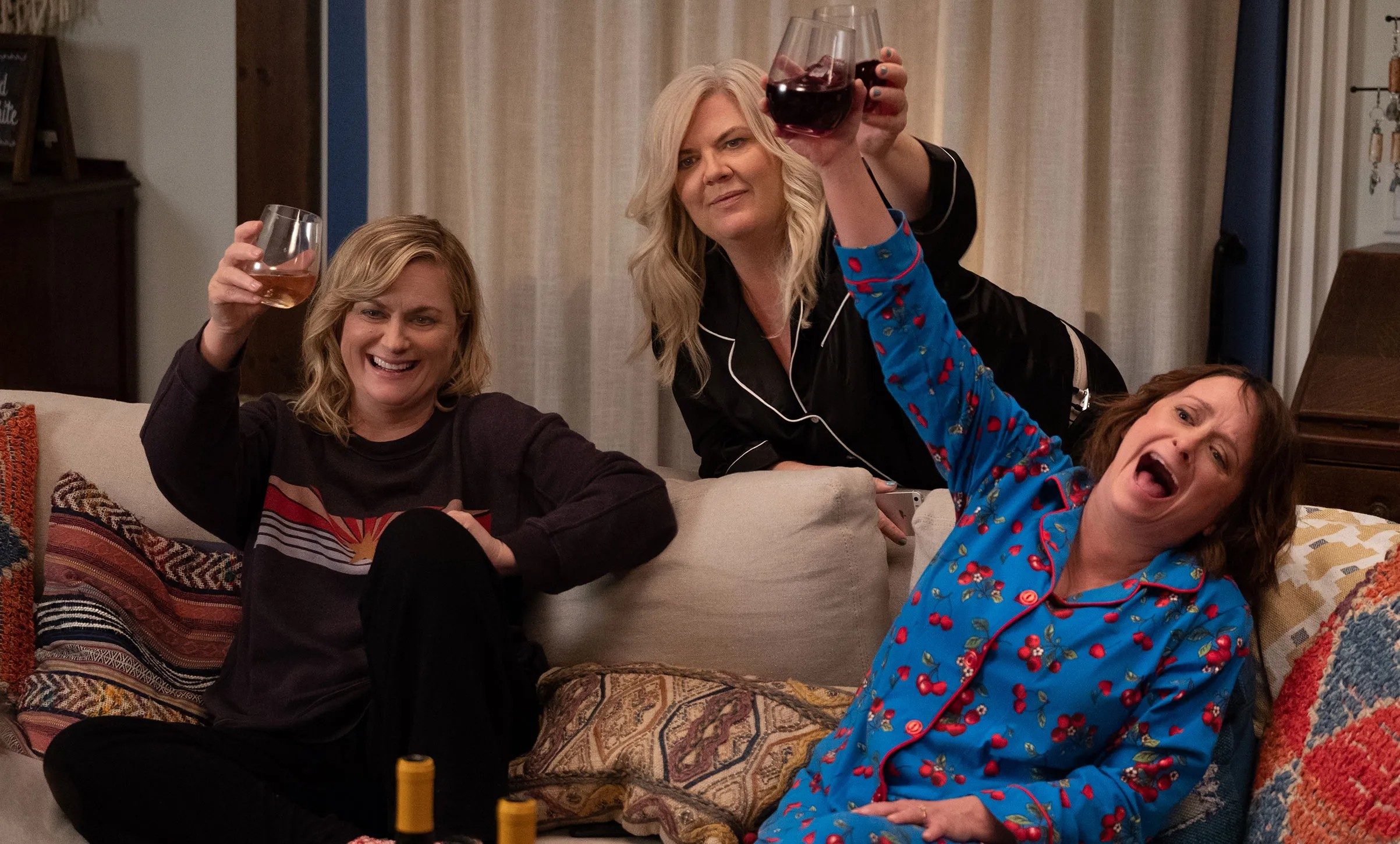 Three women raises their wine glasses in Wine Country.