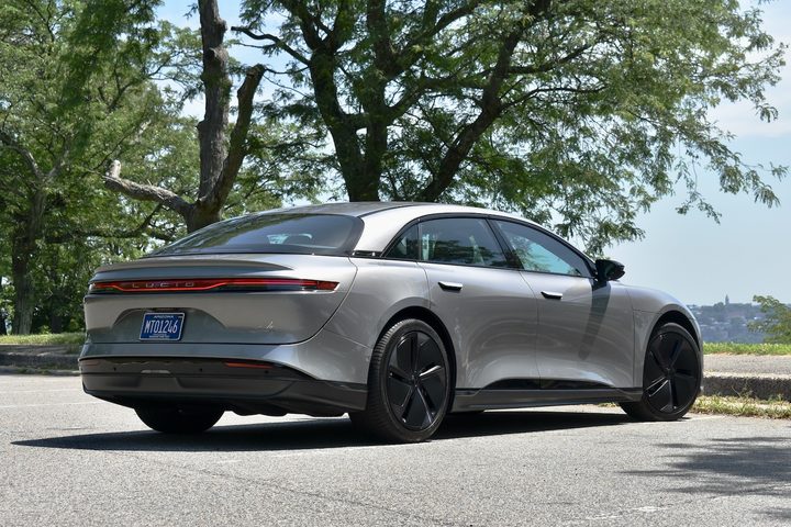 Rear three quarter view of a beige 2024 Lucid Air Touring.