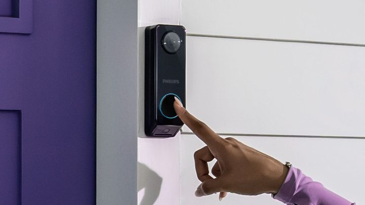 The Philips 7000 Series Video Doorbell being pressed.