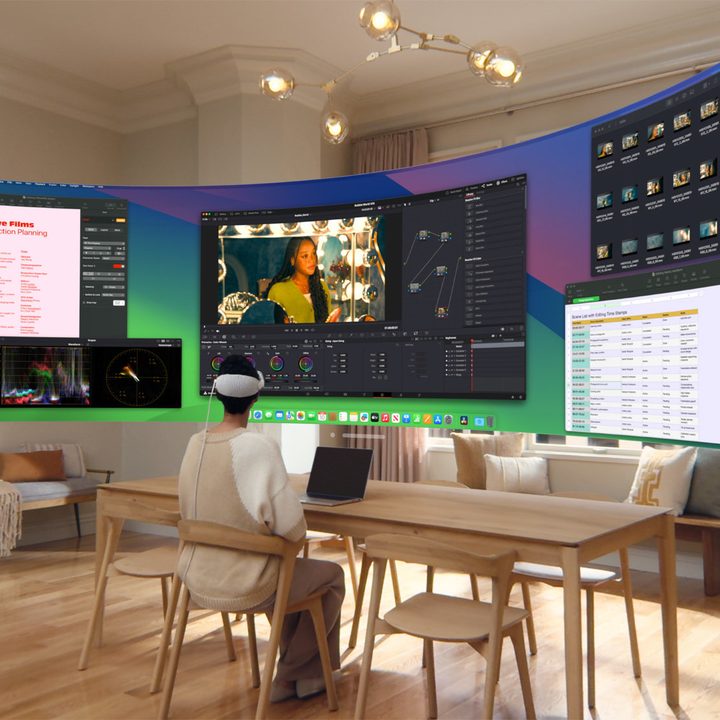 A person looks at a large Mac Virtual Display while wearing an Apple Vision Pro.