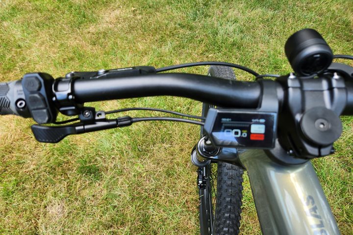 Aventon Ramblas eMTB handlebar left side with brake lever, drop seat lever, 3-button control pod, and small display.