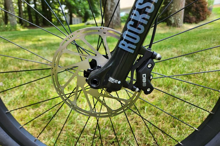 Aventon Ramblas eMTB left profile showing the SRAM DB8 4-piston disc brake with massive 203mm rotor plus the RockShox 35 front for suspension.