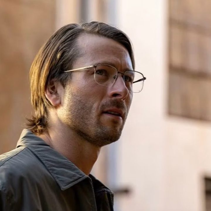Glen Powell looks nerdy and uncool in a still from Hit Man.