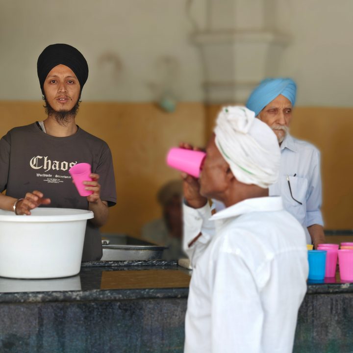Person vending water inside a temple in New Delhi, India clicked using Vivo X Fold 3 Pro with Zeiss cameras.