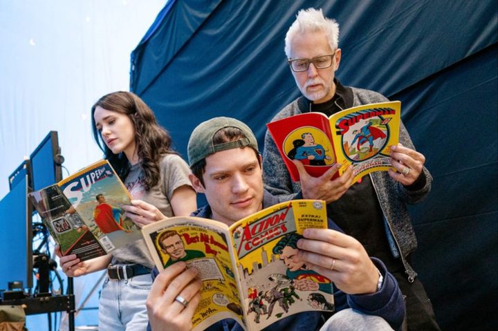 (L-R) Rachel Brosnahan, David Corenswet, and James Gunn reading Superman comics.