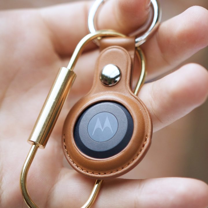 Someone holding the Moto Tag.