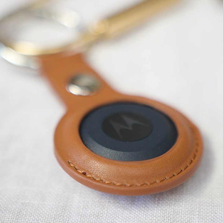 A close-up of the leather keychain case for the Moto Tag.