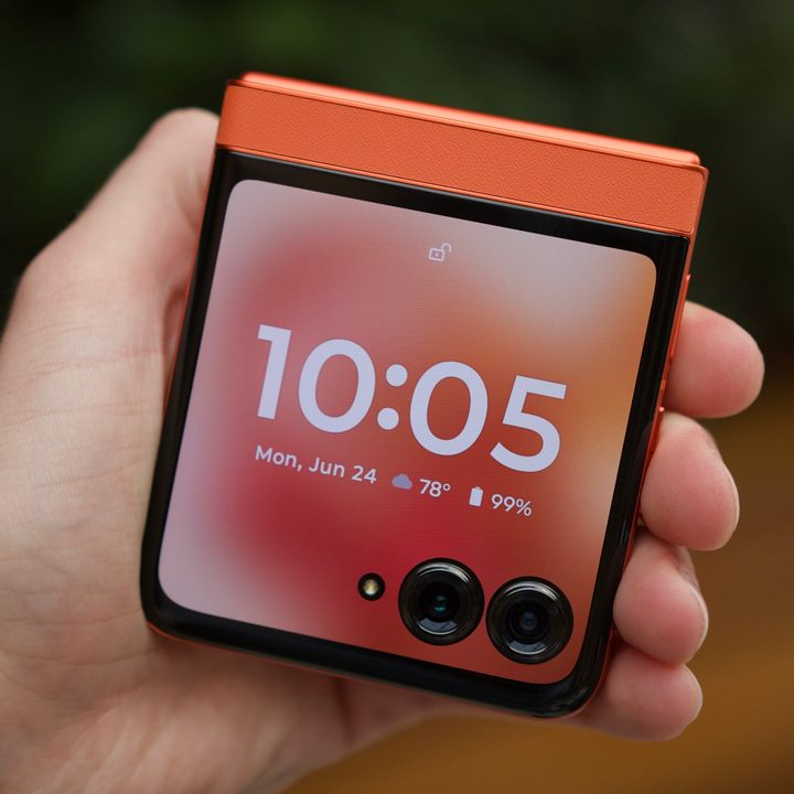 Someone holding the Motorola Razr 2024, showing its cover screen.