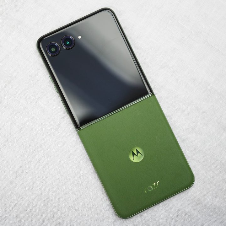 Motorola Razr Plus 2024 in green lying on a table.