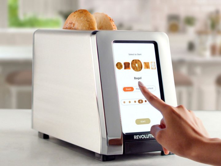 Someone using the Revolution Cooking InstaGLO R180 smart toaster in the kitchen.