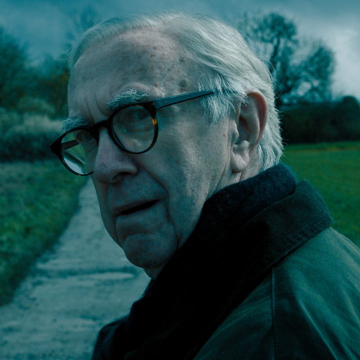 A man with glasss on turns around and looks.
