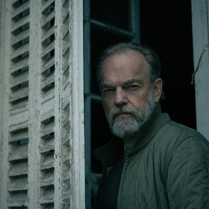 A man stands in the window and stares.