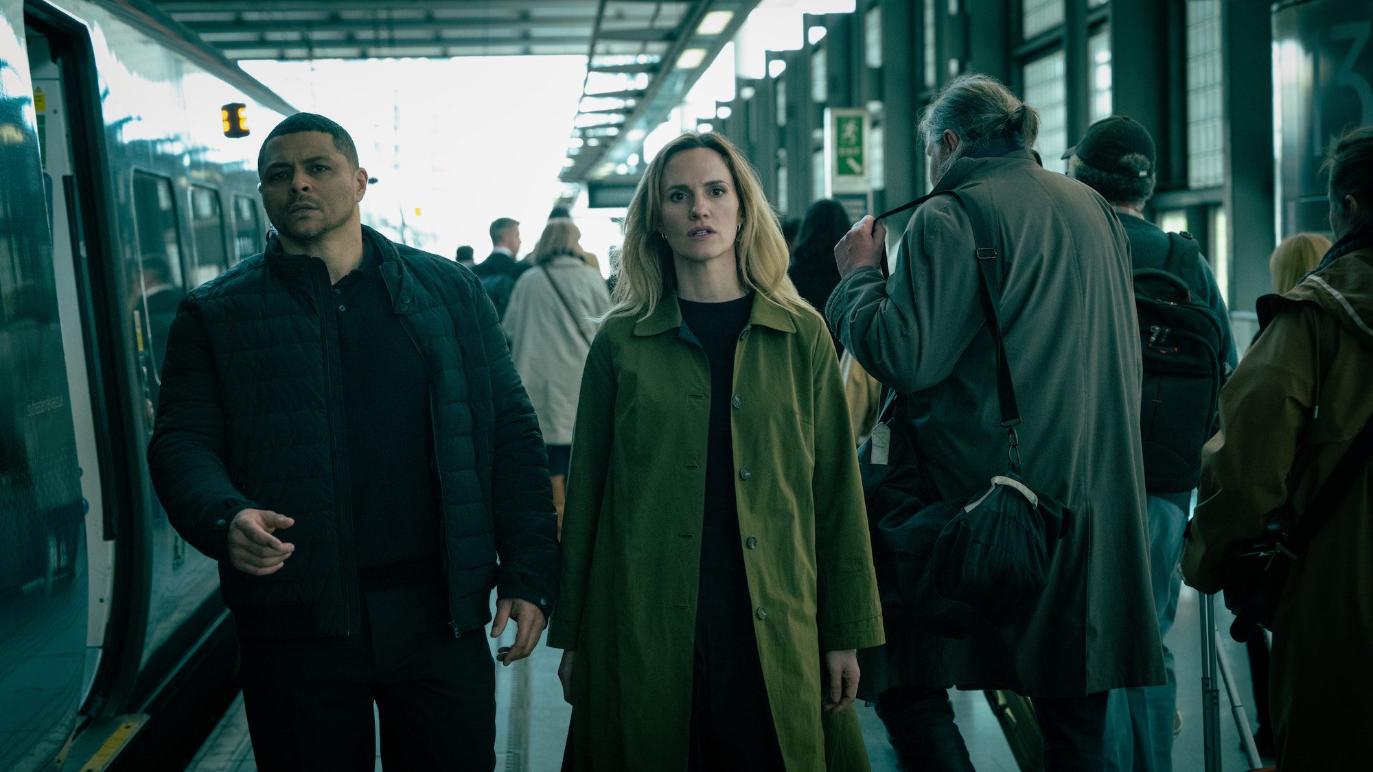 A man and woman stand next to each other and walks.