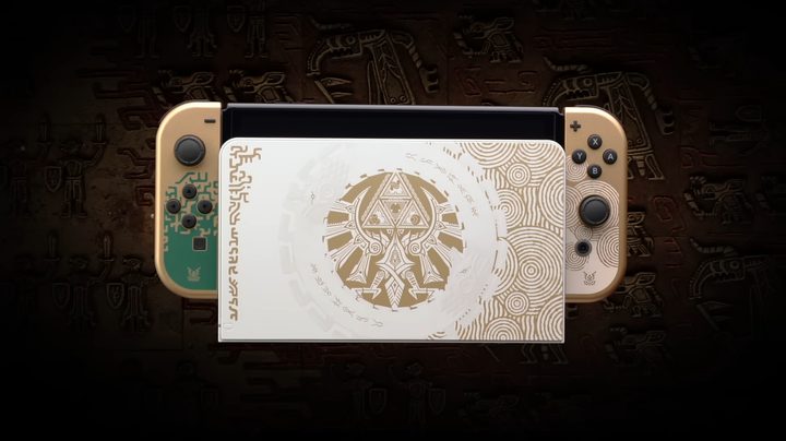A special edition Zelda Switch sits in a black room.
