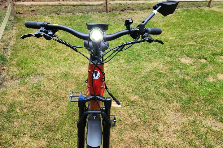Velotric Discover 2 head on with light-sensing 130 luxs headlight, adjustable front fork suspension with lockout, and optional mirror.
