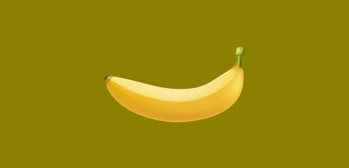 An illustration of a regular banana against an olive green b ackground. 