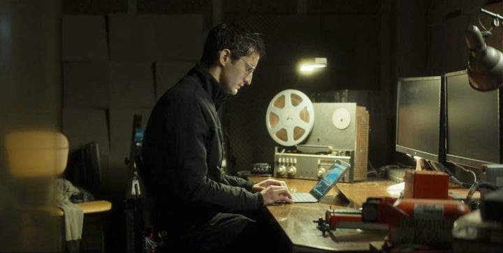 A man looks at a laptop computer in Black Box.