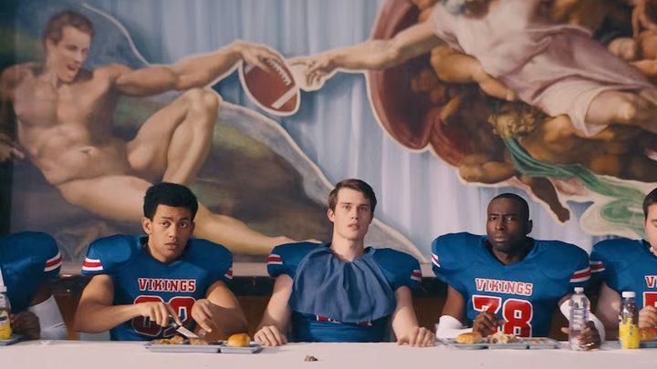 5 football players sit at a table in Bottoms.