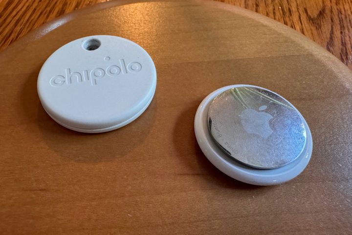 A Google ONE Point next to an Apple AirTag.