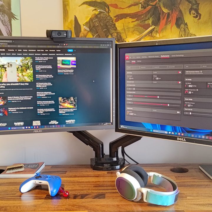 Pair of monitors on a desk with a monitor arm.