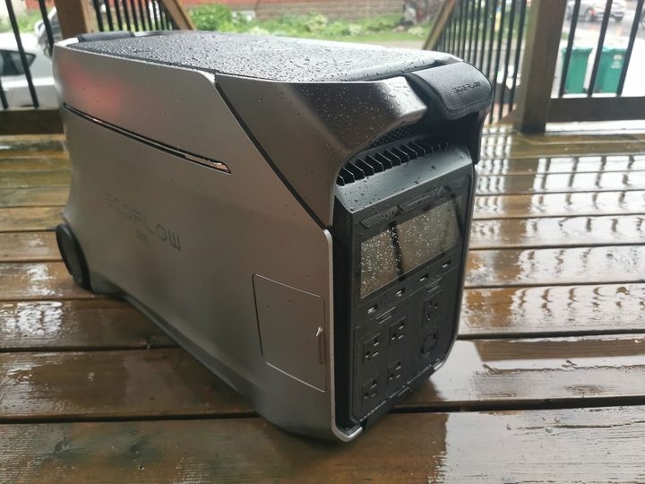 The EcoFlow Delta Pro 3 power station on a balcony in the rain.