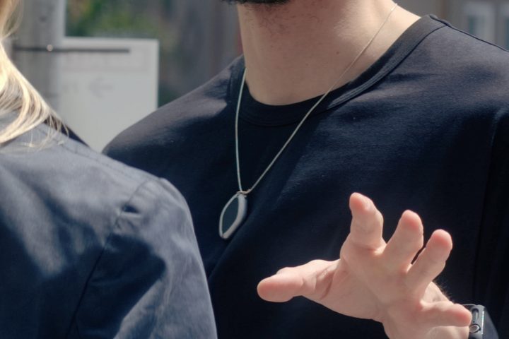 A person wearing the Based Hardware Friend AI necklace.