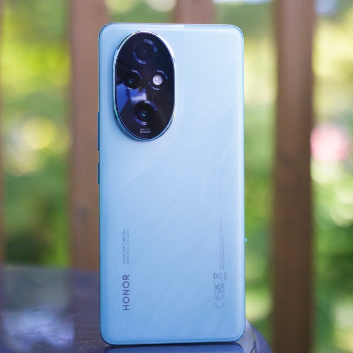 The Honor 200 Pro sitting upright outside.