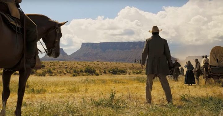 A man stands and looks at a mountain in Horizon: An American Saga.