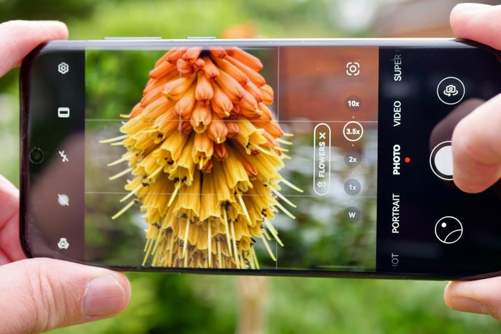 A person taking a photo with the Huawei Pura 70 Ultra.