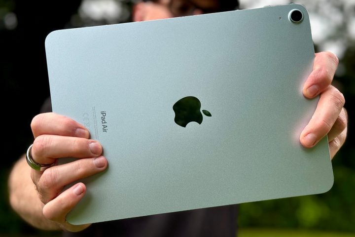 A person holding the iPad Air (2024) and taking a photo.