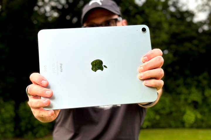 A person holding the iPad Air (2024) and taking a photo.