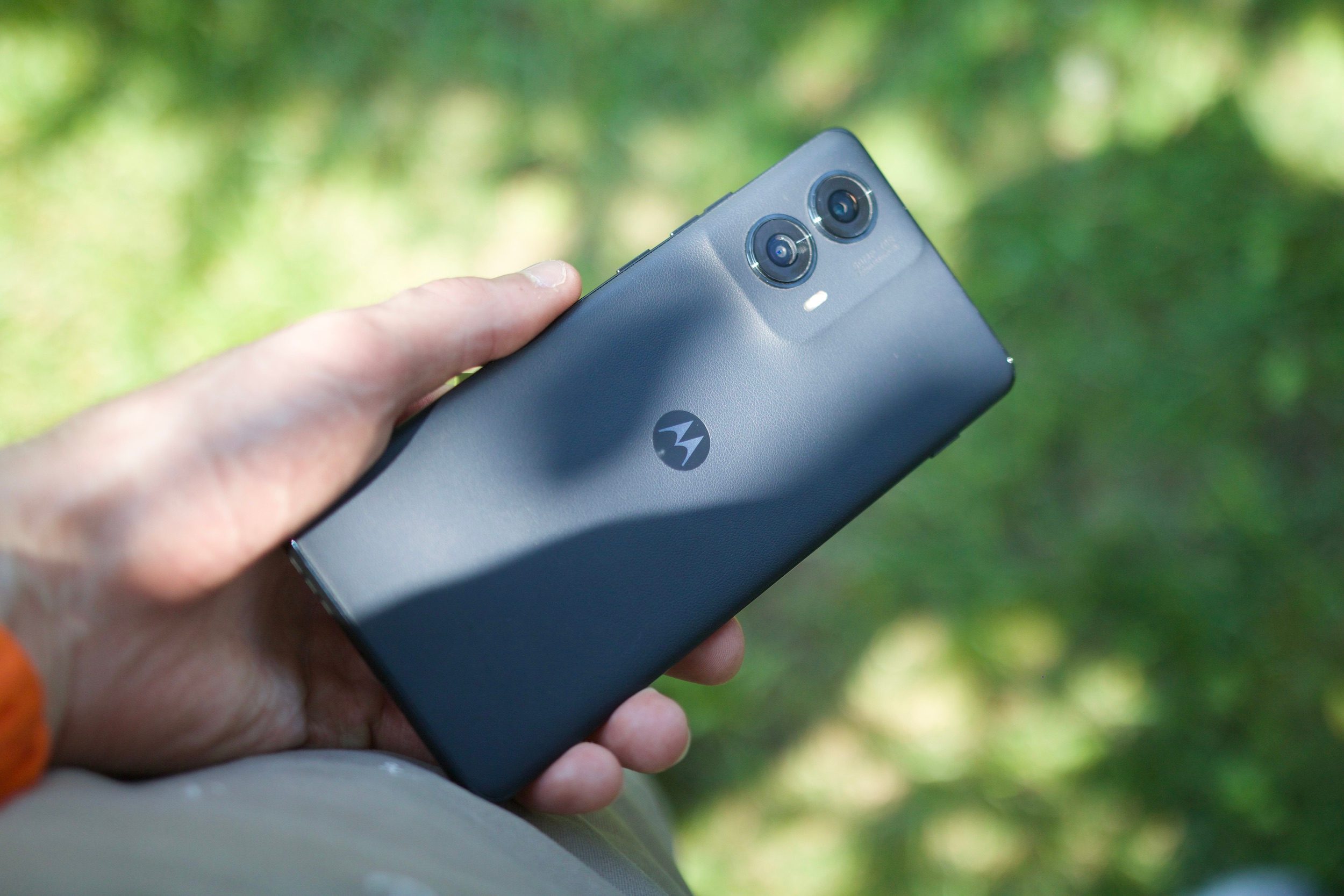 Someone holding the Motorola Edge (2024) outside.
