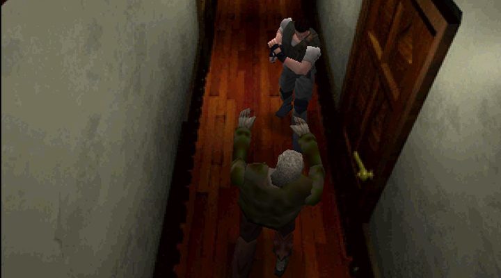 Chris Redfield shooting a zombie in a hallway looking at a door behind him in the original Resident Evil game.