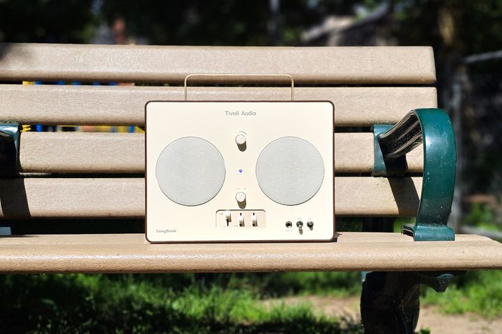 Tivoli Audio SongBook on a park bench.