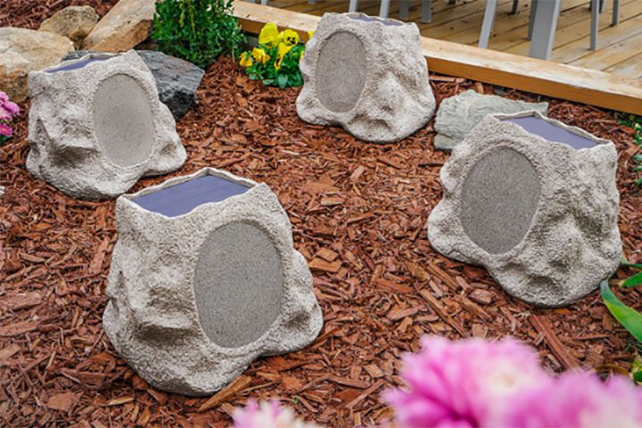 Four Victrola Rock Speaker Connects in a garden.