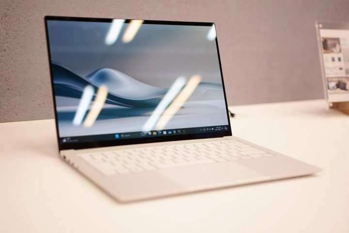 The Asus Zenbook S 14 open on a white table.