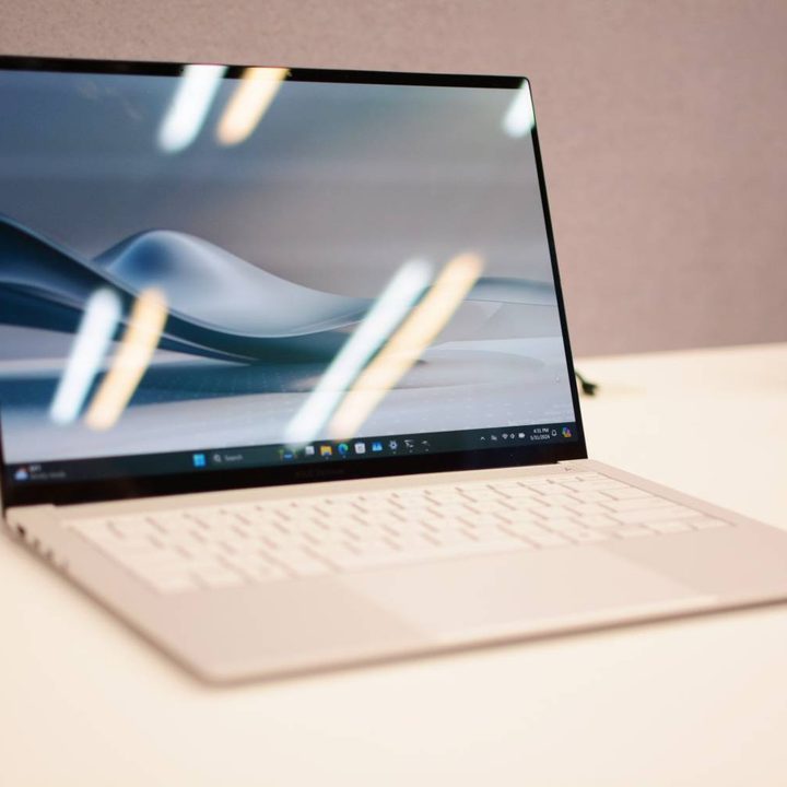 The Asus Zenbook S 14 open on a white table.