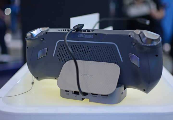 The Zotac Zone handheld gaming console placed on a dock.