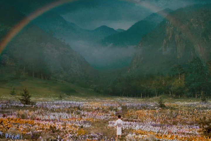 A young boy walks toward a rainbow in Dreams.