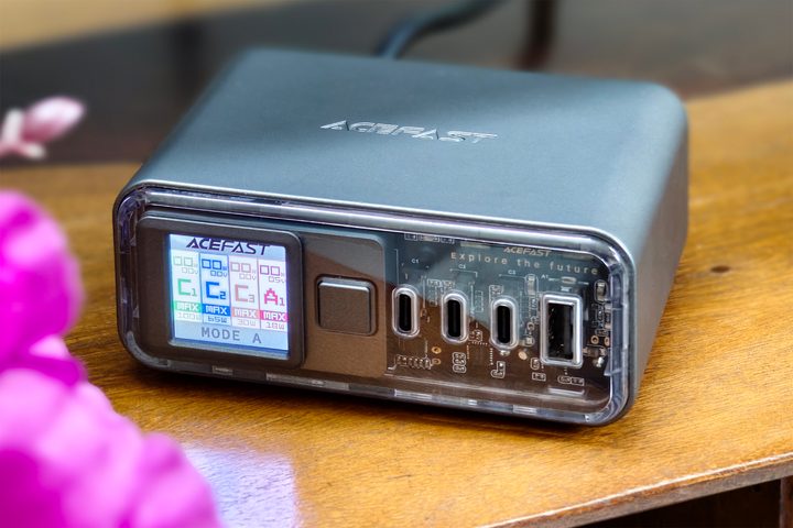 Acefast Z4 218W fast charger with display and transparent front panel kept on a wooden surface.