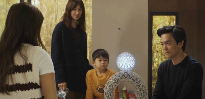 A family looks at a glowing ball in Afraid.