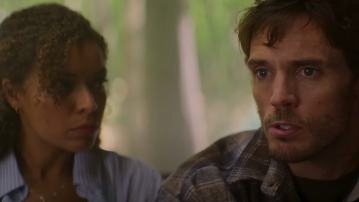 A man looks scared as he speaks while sitting next to his wife.