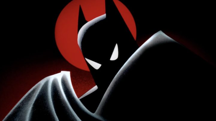 Batman's silhouette on a red moon in Batman: The Animated Series key art.